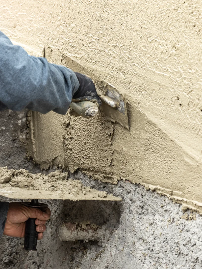 Applying cement plaster to an exterior wall